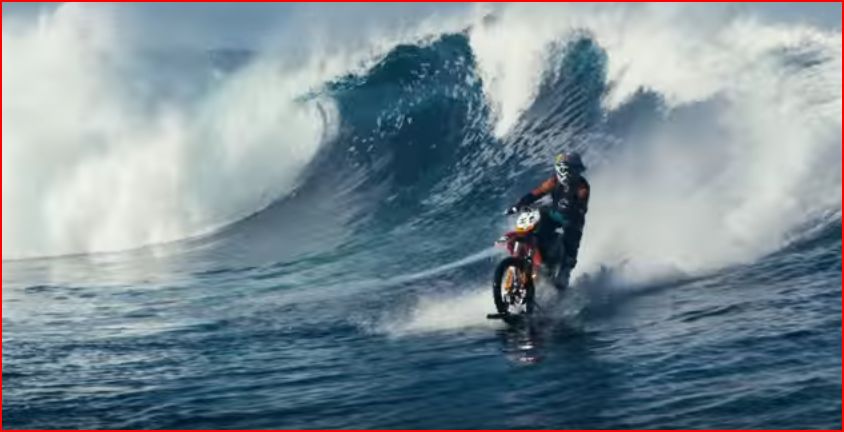 Motorcycle riding a wave
