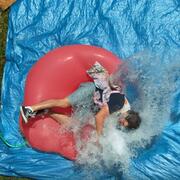 Dan falling onto giant water balloon
