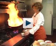 Woman holding pan on fire