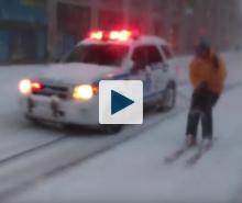 NYPD car and man on snow ski's