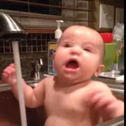 Surprised baby in bath