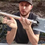 Man holding camping shovel