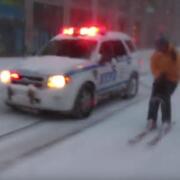 NYPD car and man on snow ski's