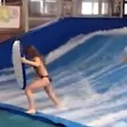 Woman about to fall on surfing ride